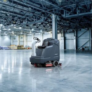 A Nilfisk Floor Sweeper sitting idle in a clean warehouse
