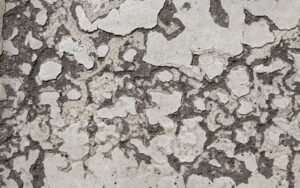 A badly damaged concrete garage floor requiring shotblasting