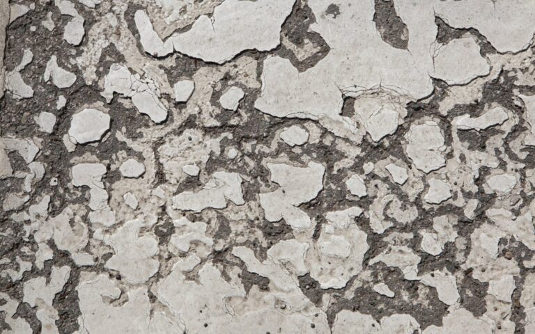 A badly damaged concrete garage floor requiring shotblasting